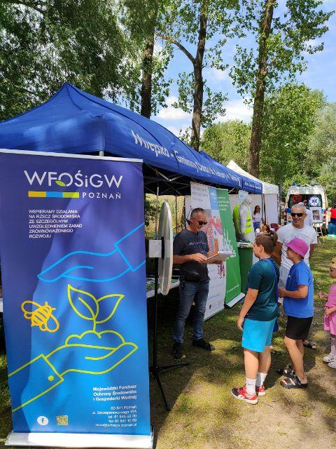 Stoisko WFOŚiGW w Poznaniu - dzieci podczas gry w ekologiczne koło fortuny